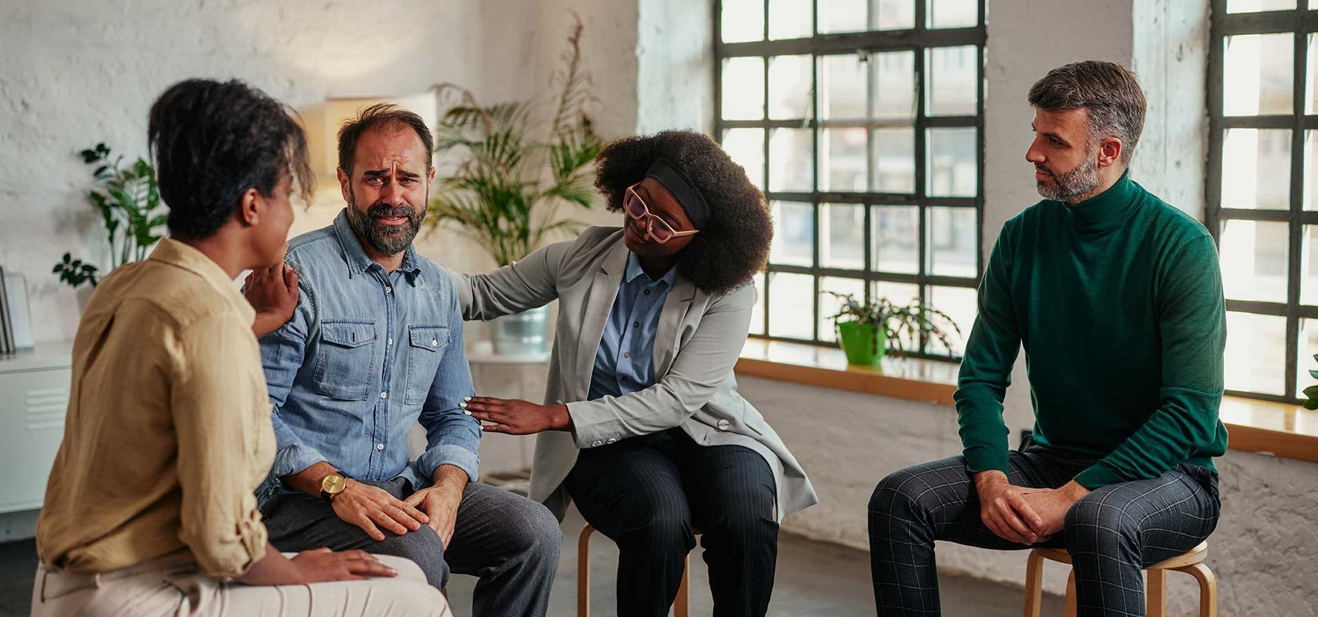 support-group-patients-comforting-man-at-therapy-s-6Q4CFG4-1.jpg